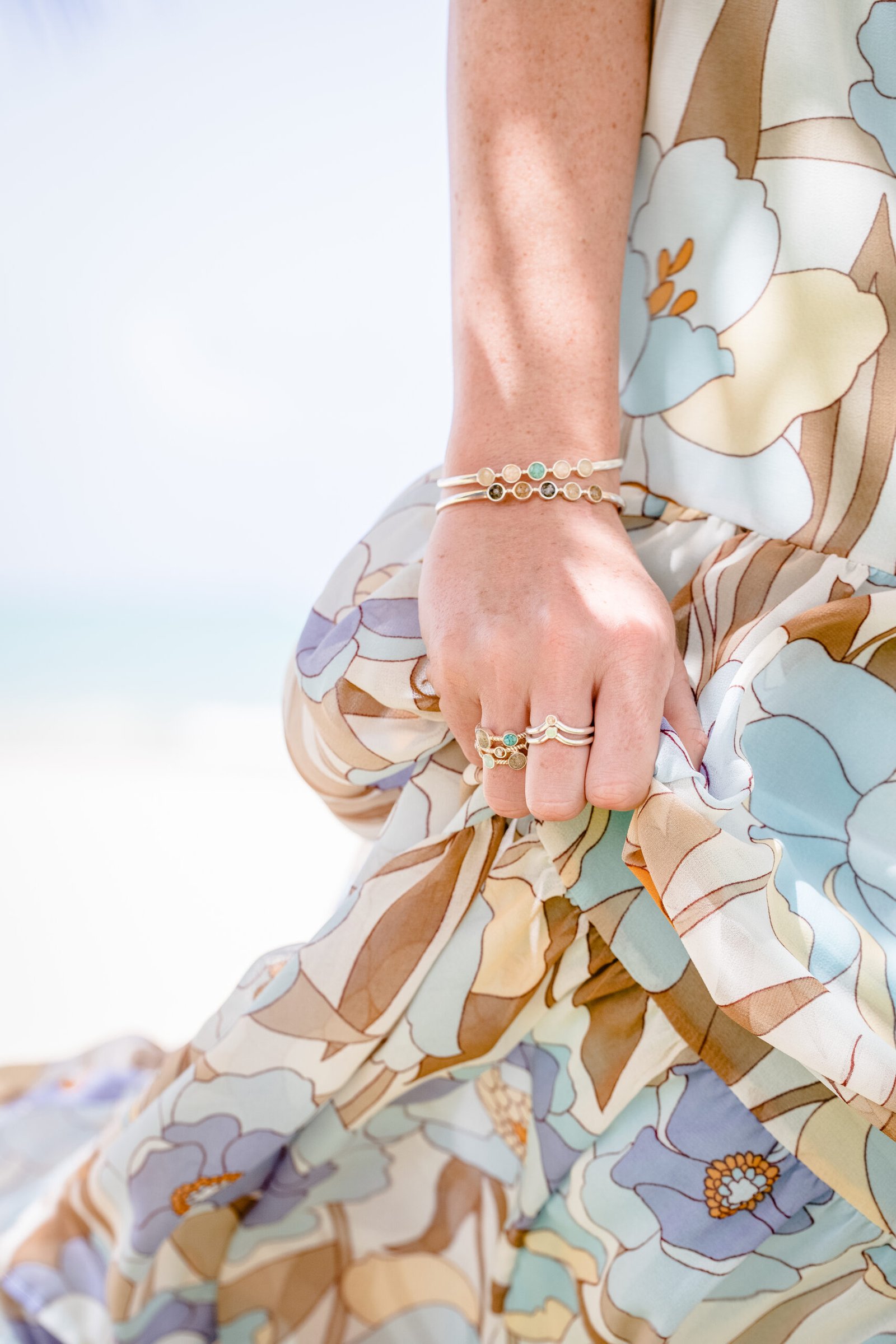 Photograpj of wrist wearing the Endless Summer Bracelet cuff in sterling silver with 5 earth elements for Artful Bracelets's Mother's Day Gift Guide.